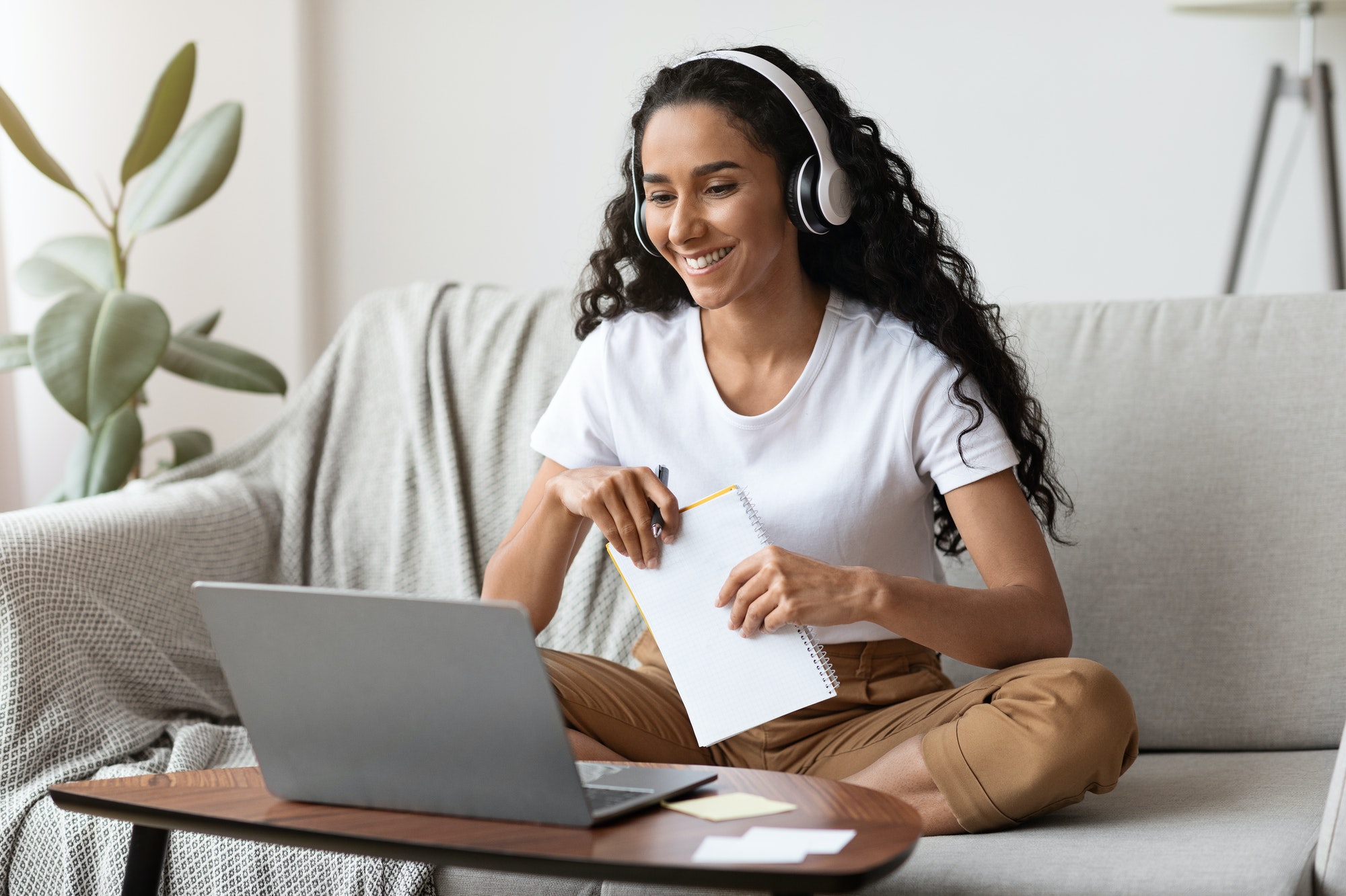 cheerful-lady-attending-online-course-using-laptop-and-wireless-headset-1.jpg